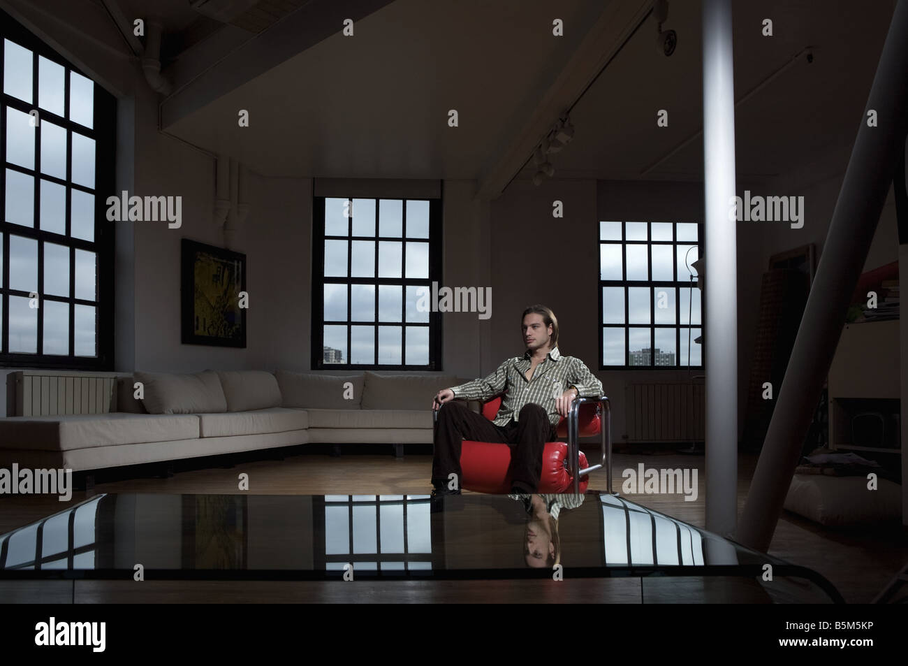 A young man alone in a living room Stock Photo - Alamy