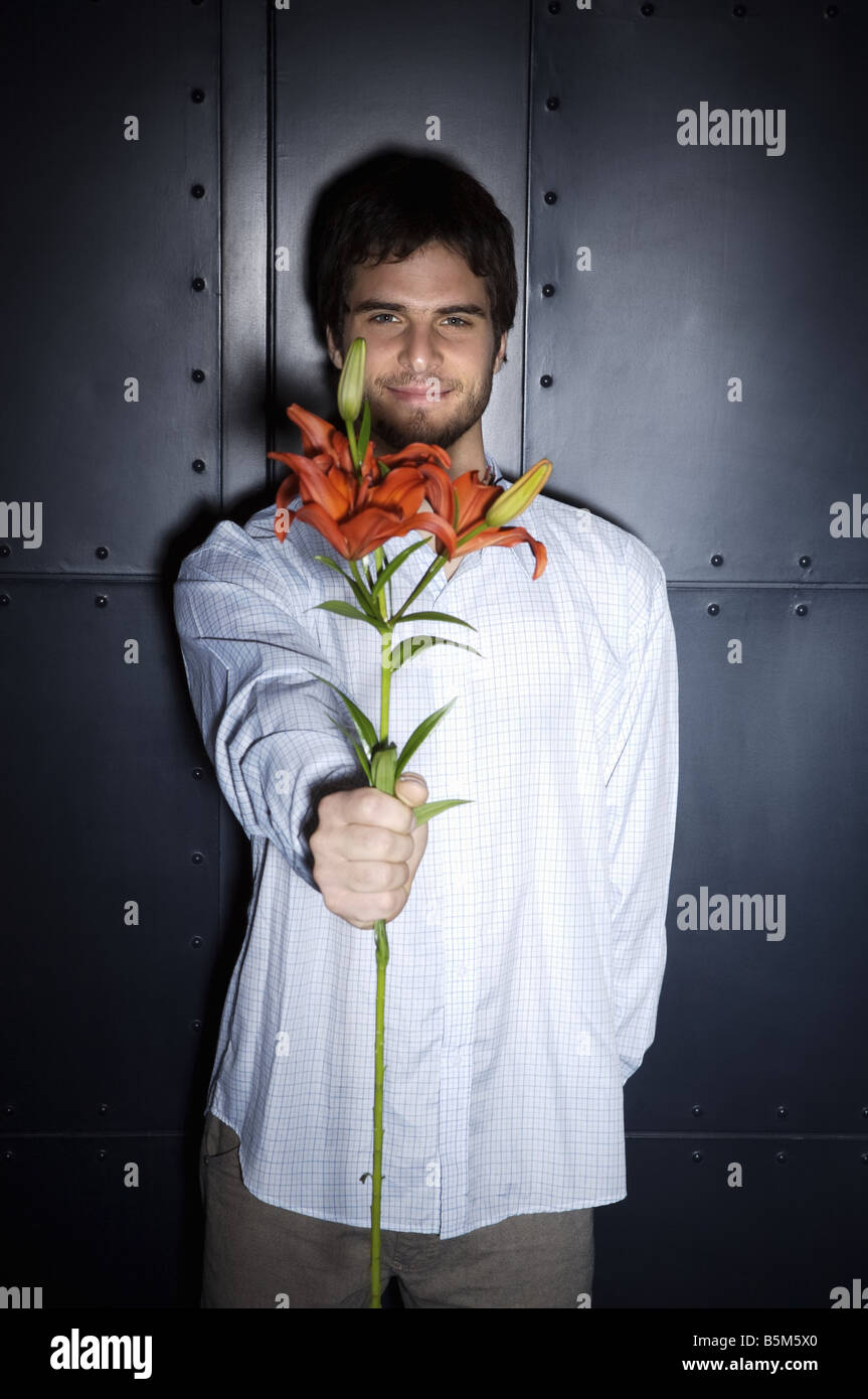 Young man holding flowers Stock Photo