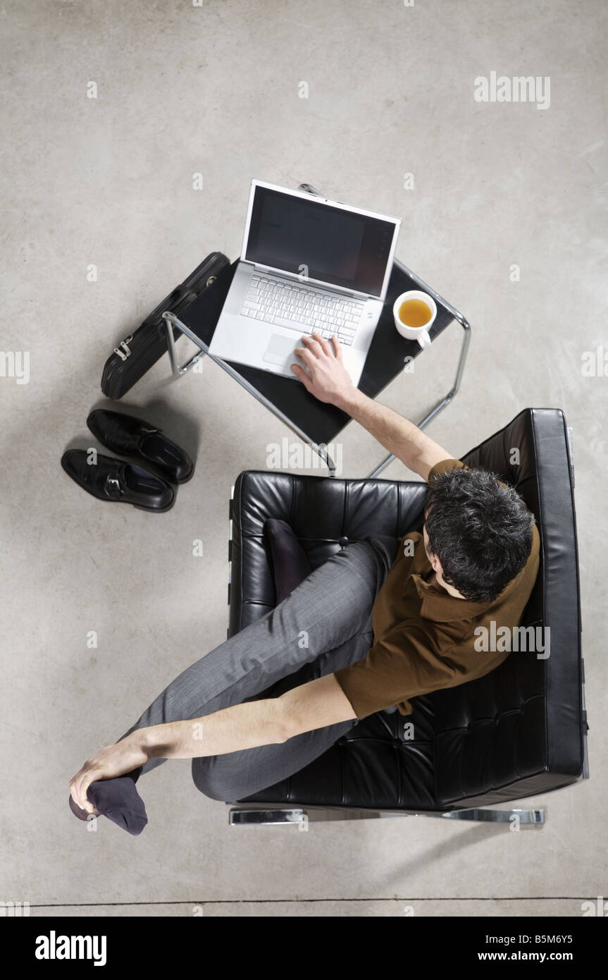 Businessman practicing yoga at office Stock Photo - Alamy
