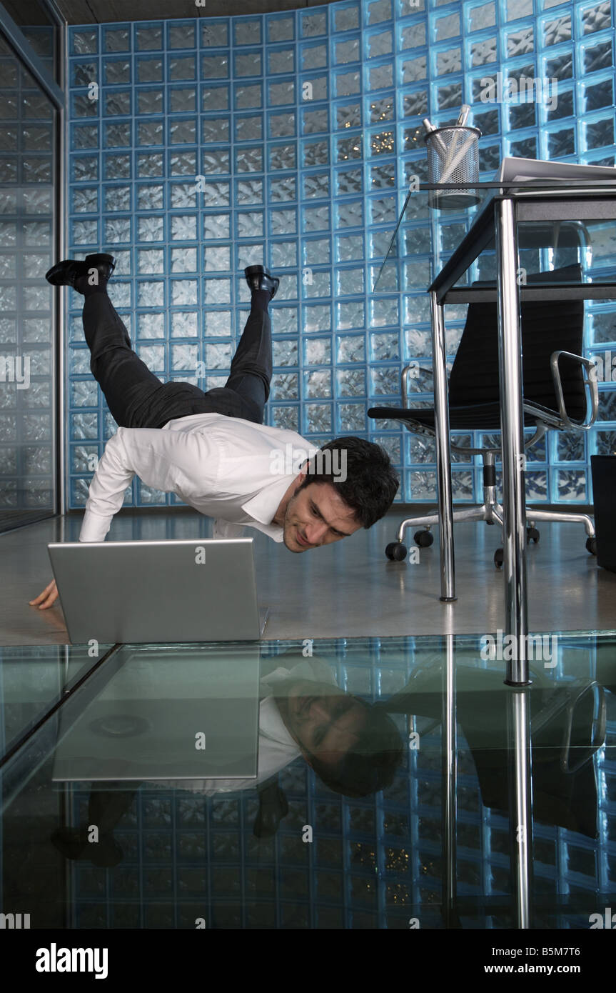Businessman practicing yoga at the office Stock Photo - Alamy
