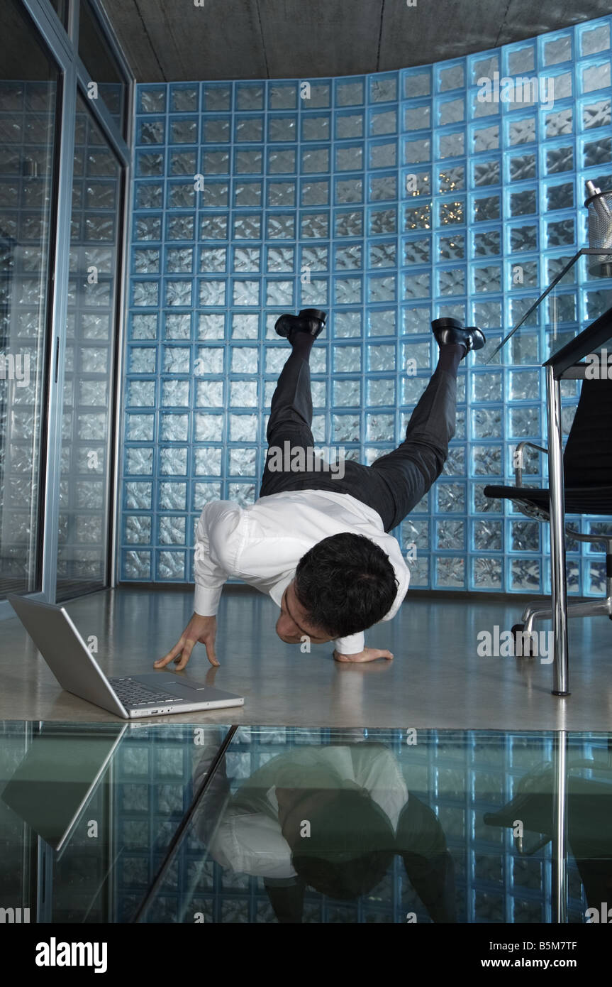 Businessman practicing yoga at the office Stock Photo - Alamy