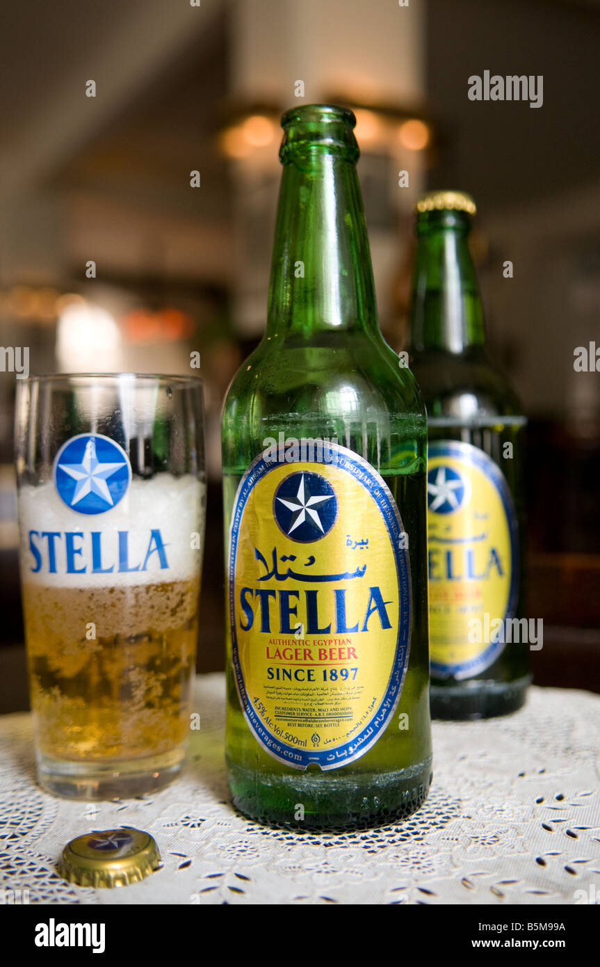 Bottles and a beer mug filled with the Egyptian Stella Euro Pale Lager style beer brewed by Al Ahram Beverages Company in Giza, Egypt Stock Photo