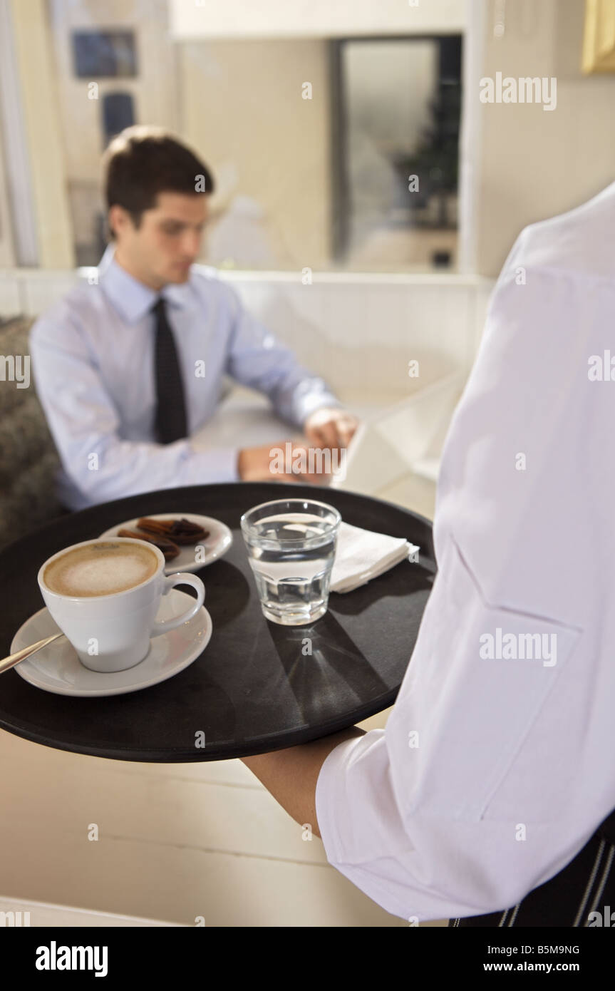 Waitress serving coffee Stock Photo Alamy