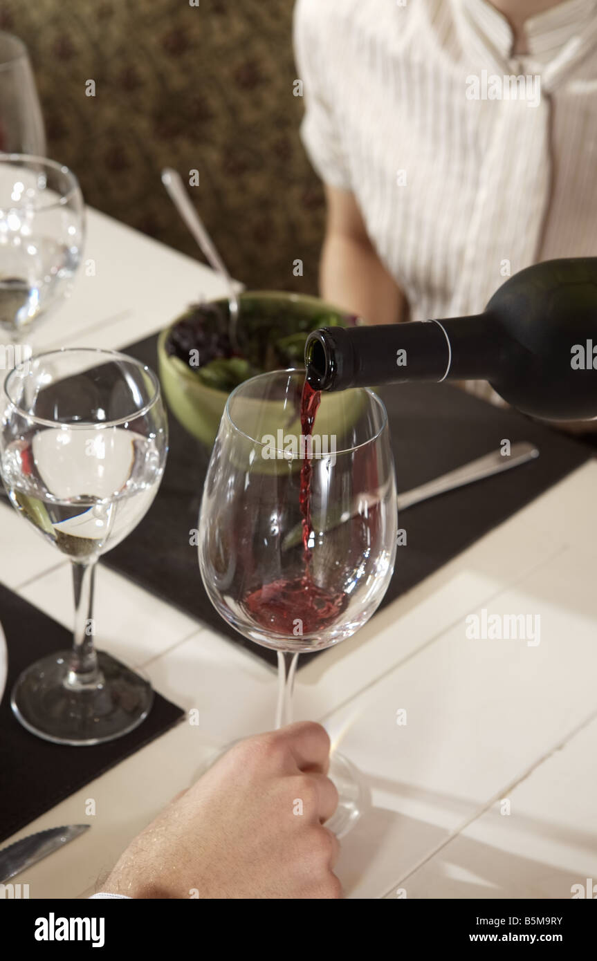 A glass of wine being served Stock Photo Alamy