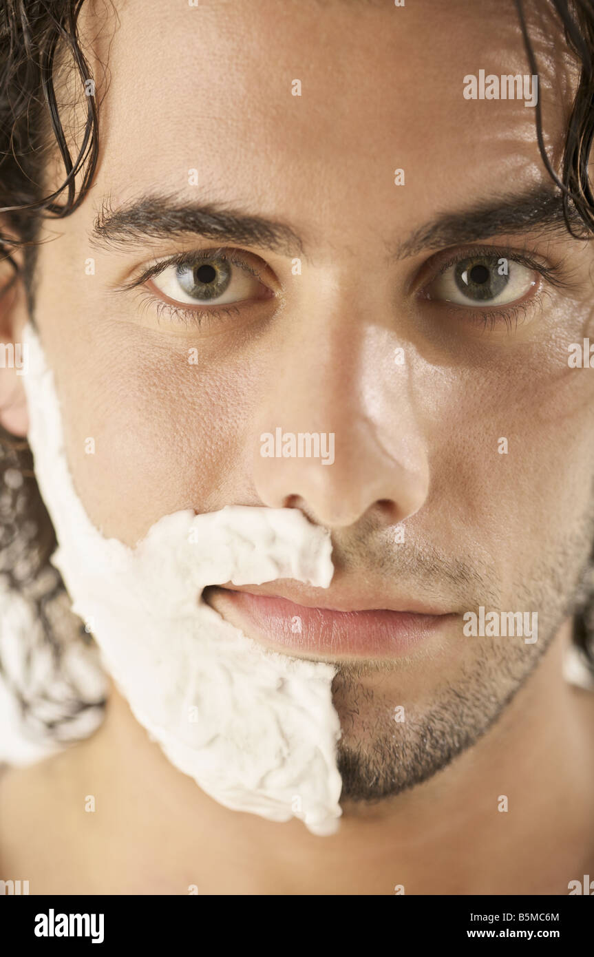 A man with shaving cream on half his face Stock Photo Alamy
