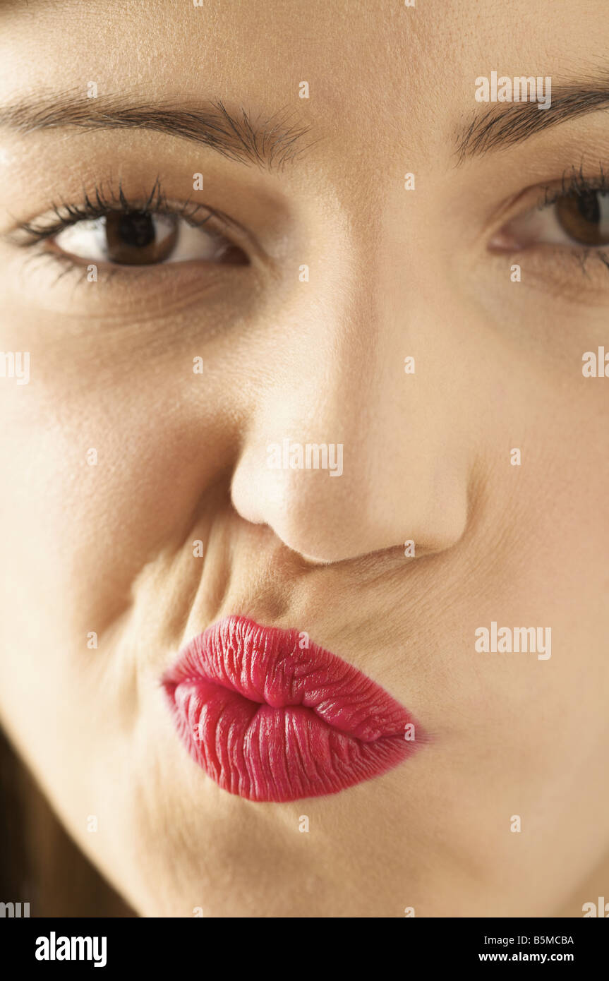 A woman puckering her lips to the side Stock Photo - Alamy