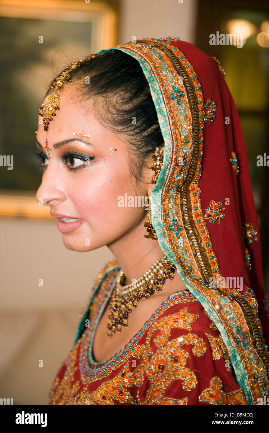 beautiful sikh bride getting ready on her day of the ceremony with all her bangles and traditional dress Stock Photo