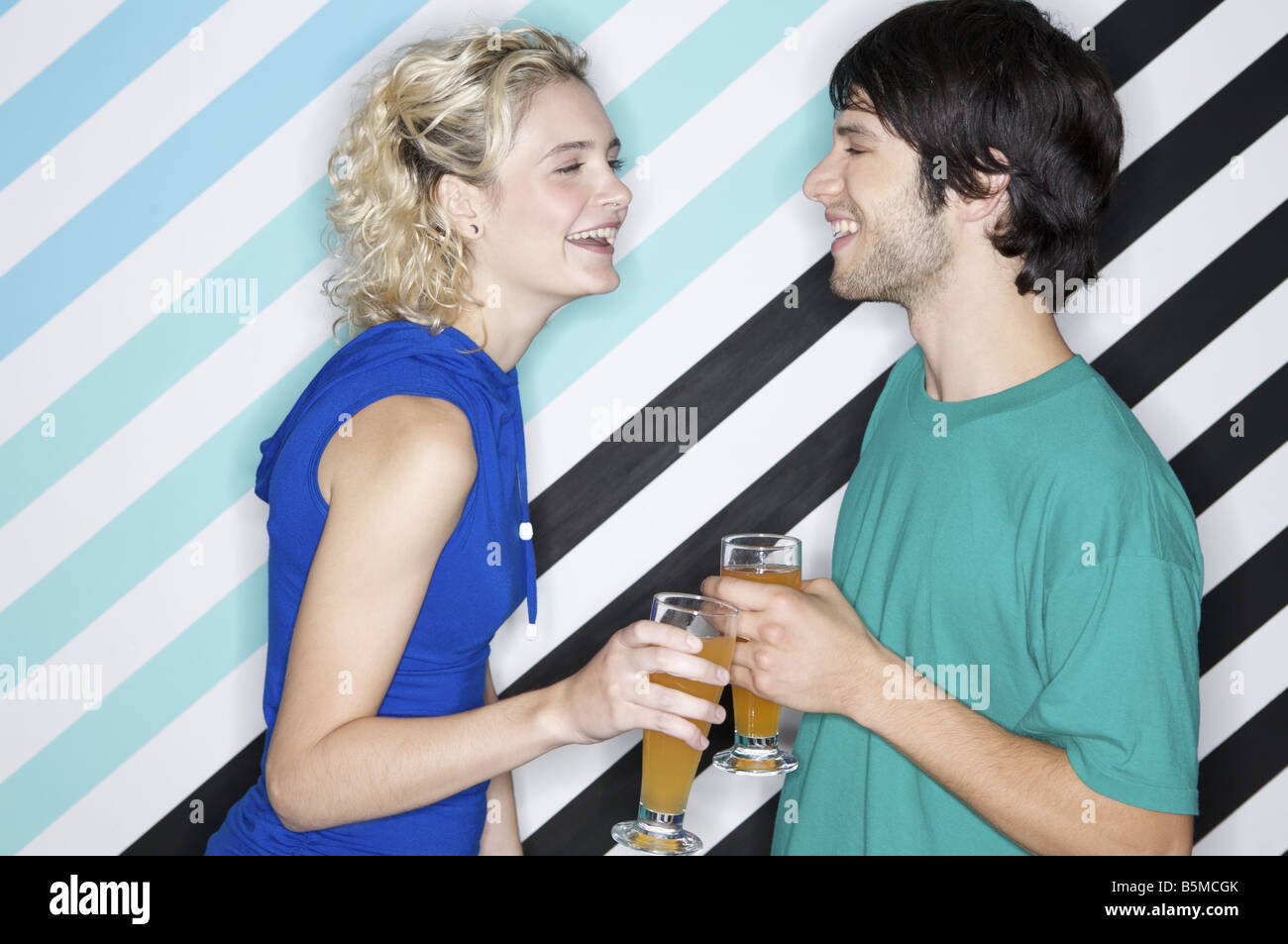 A teenage couple holding beverages Stock Photo