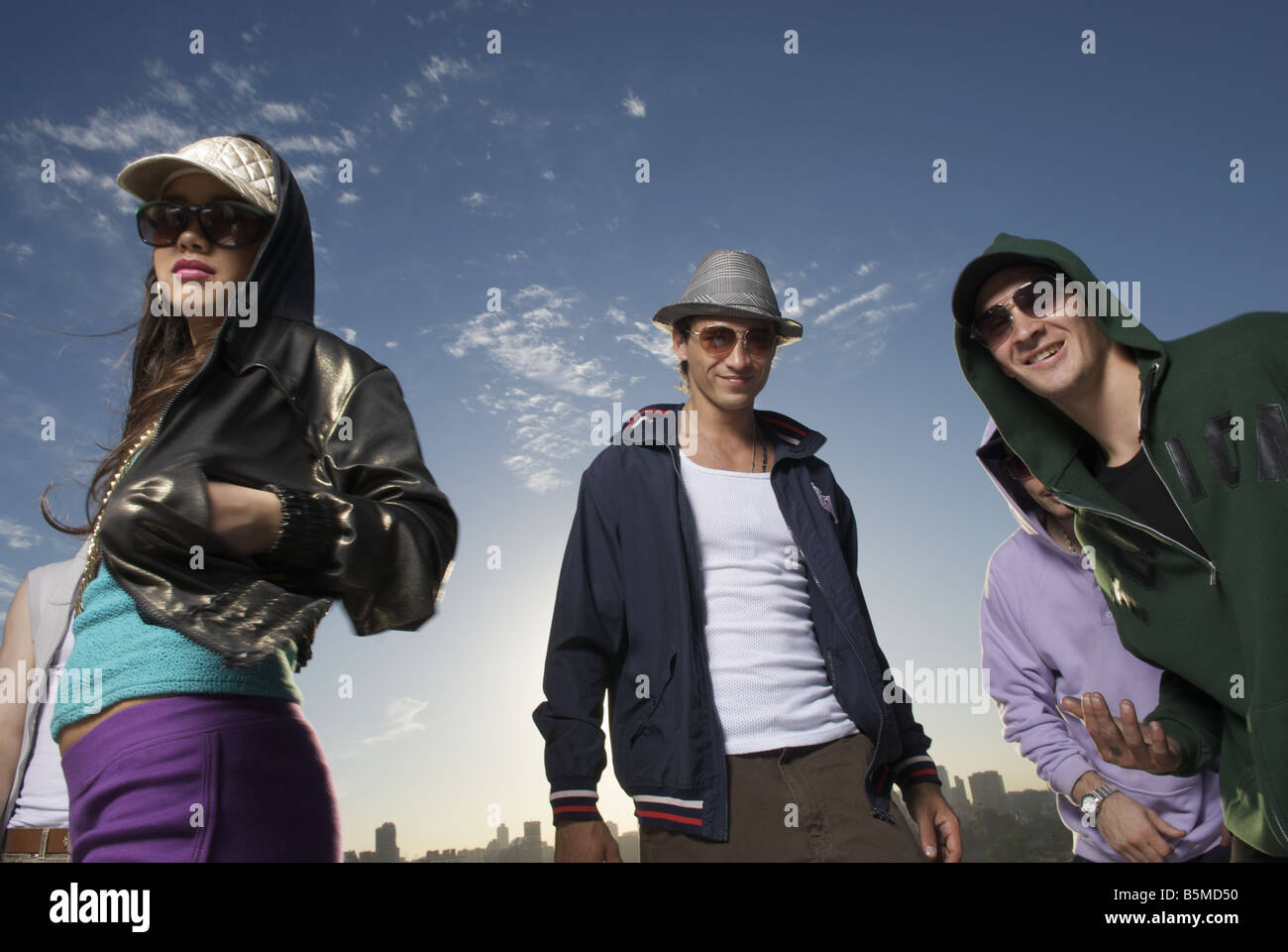 Three young men and a teenage girl Stock Photo - Alamy