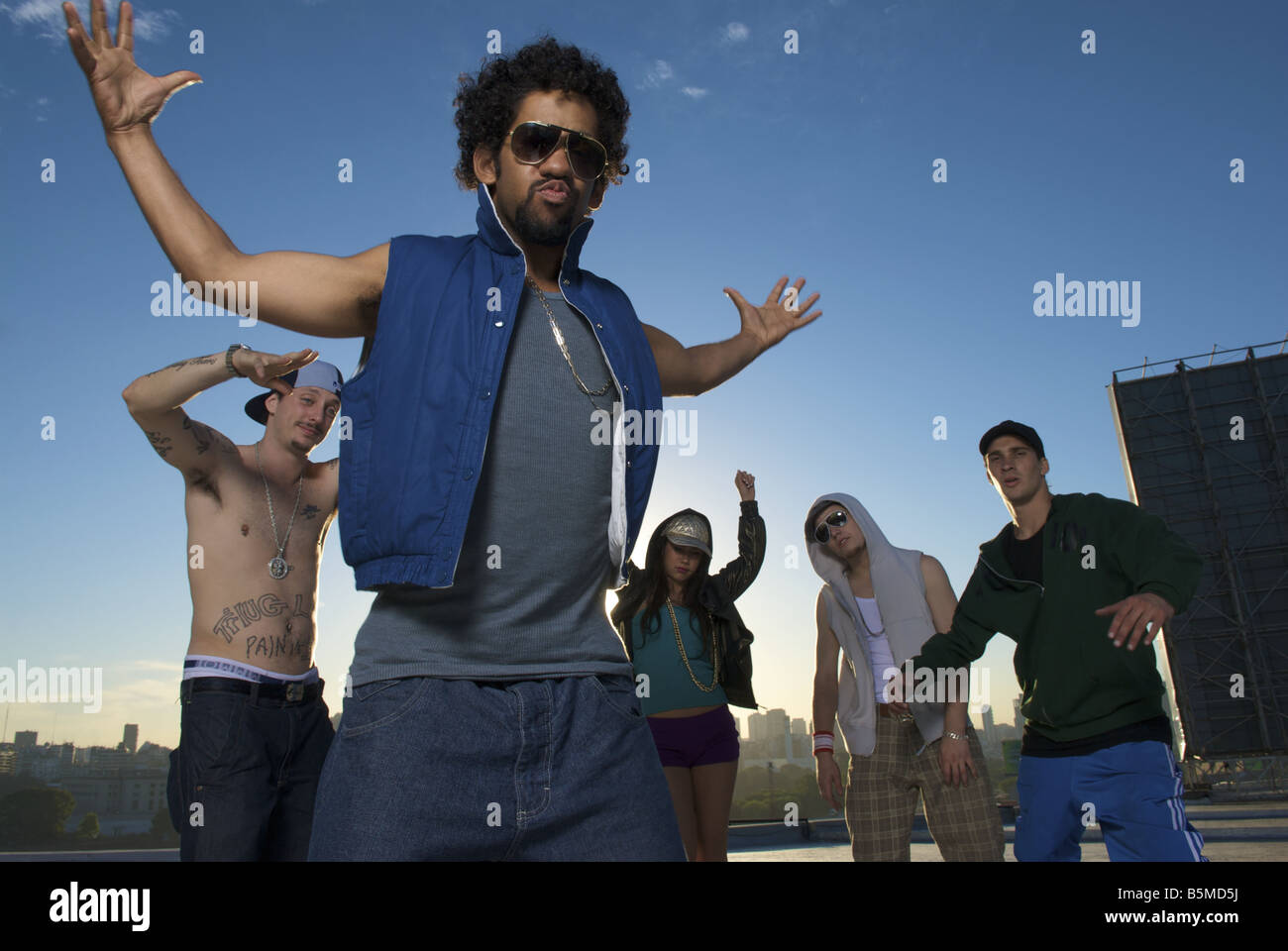 A group of young men and a teenage girl on a roof Stock Photo - Alamy