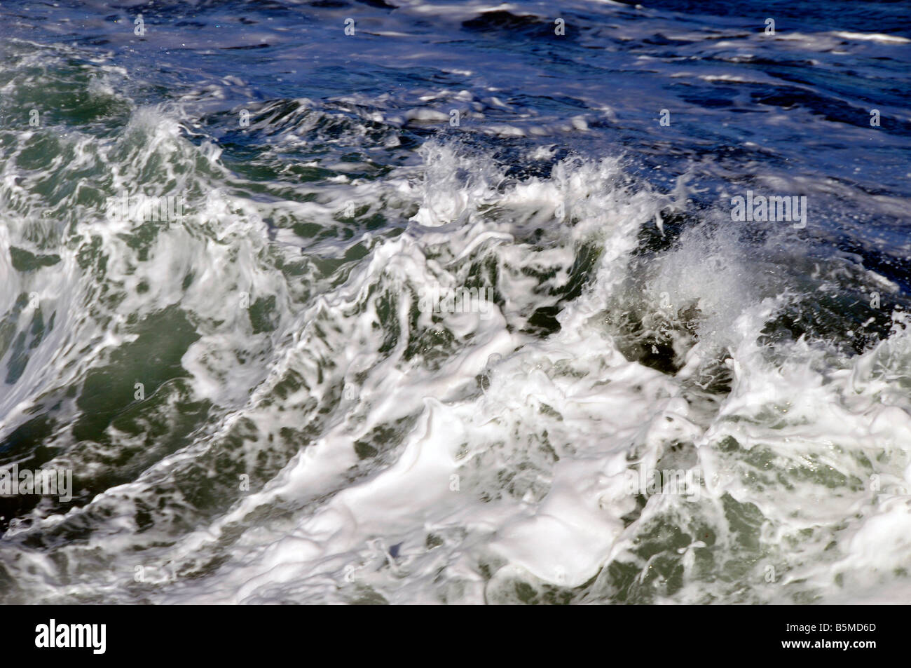 sea waves rough water wind detail stormy north sea curves bubbles churned white horses splashing Stock Photo