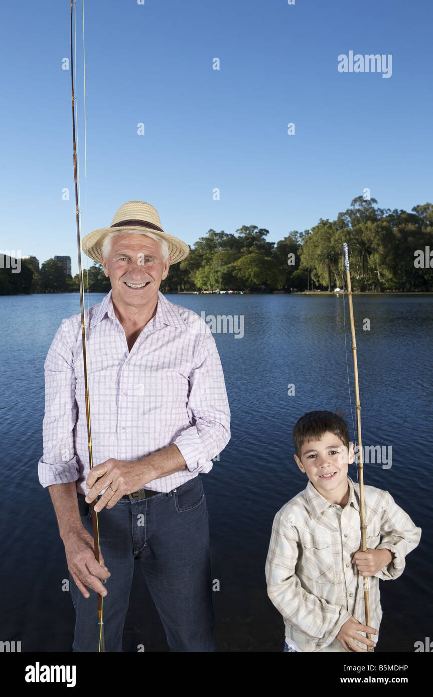 An elderly man fishing with boy Stock Photo