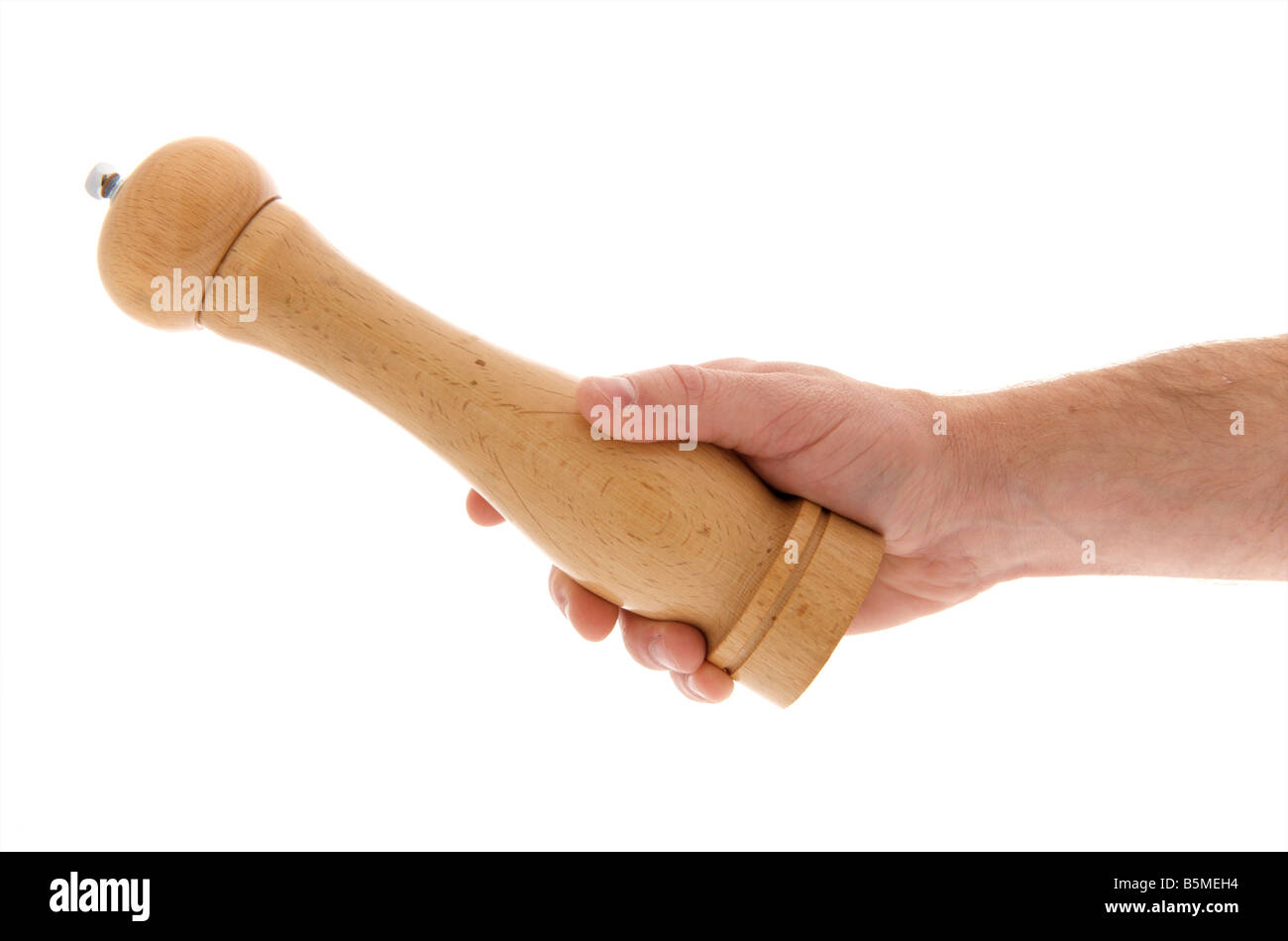 mans male right outstretched hand holding a pepper grinder against a white background Stock Photo