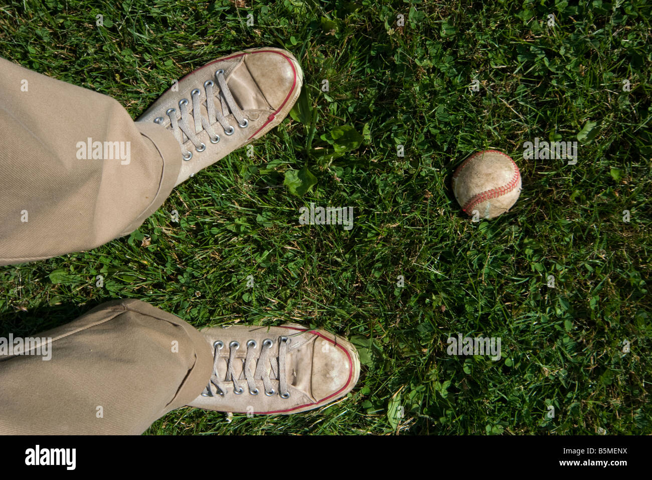 Close up of a man s feet next to a baseball MODEL RELEASED Stock Photo