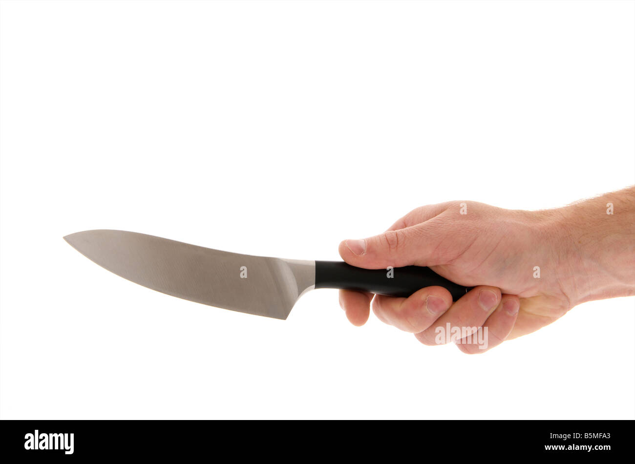 mans male right outstretched hand holding a kitchen knife against a white background Stock Photo