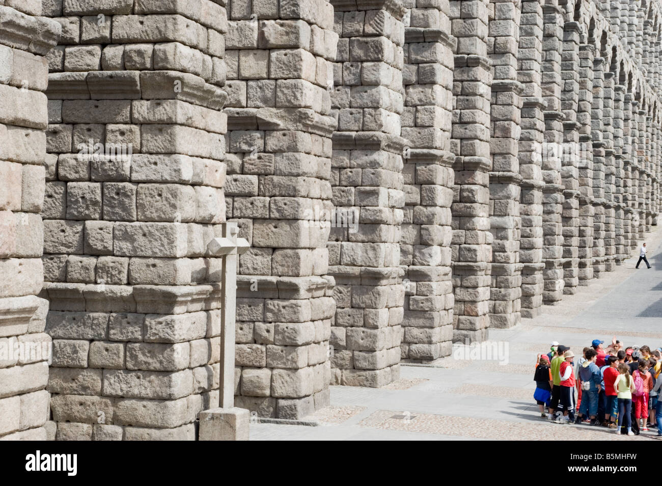 Class of school children being shown the Roman Aqueduct in Segovia, Spain. Stock Photo