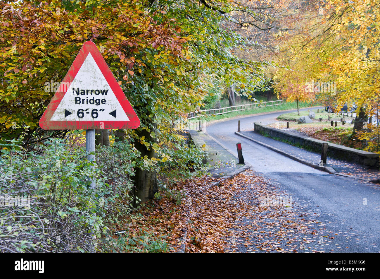 Narrow bridge road sign, with 7.5 ton/tonne limit.  Autumn colours Stock Photo