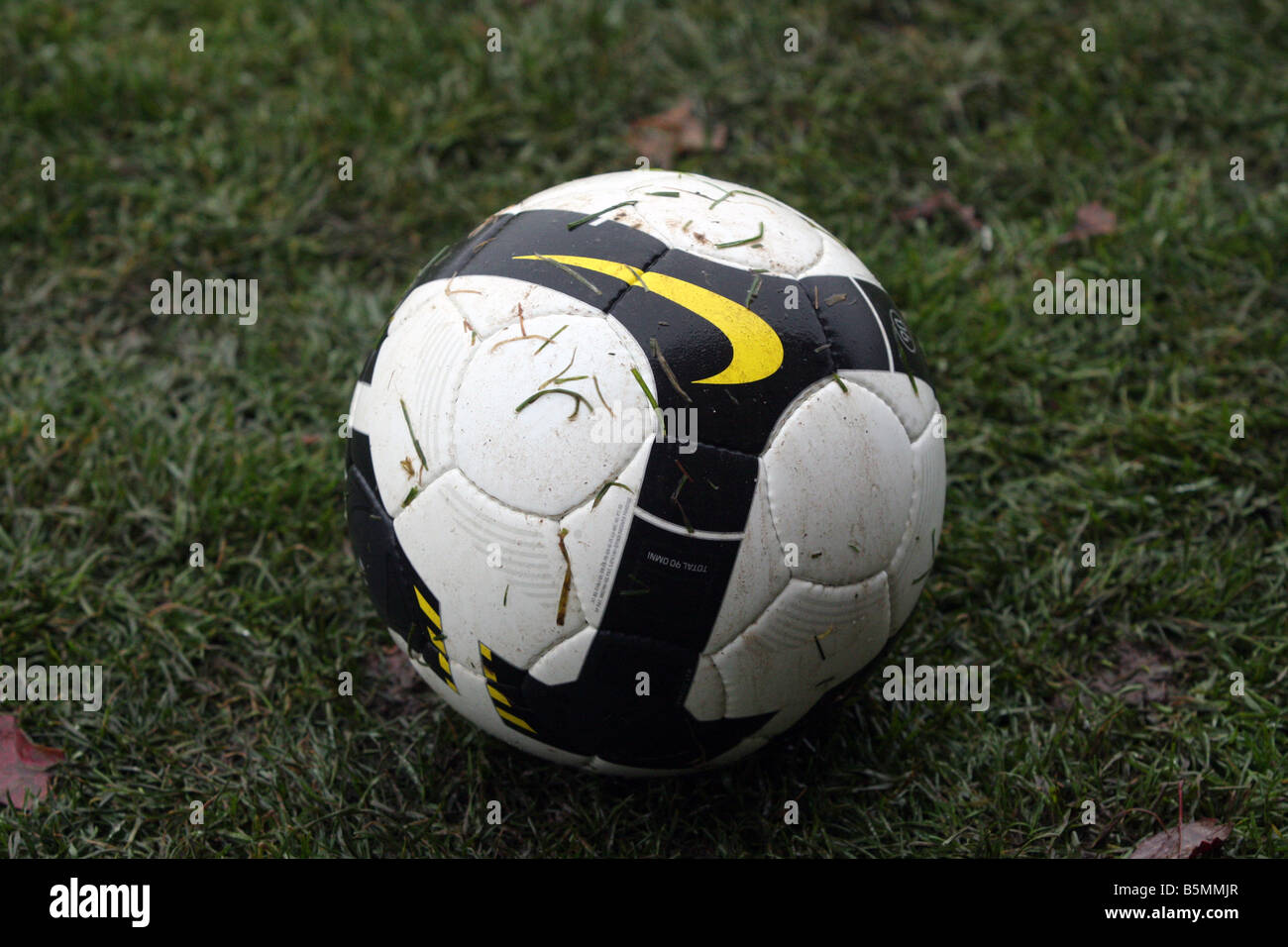 A soccer ball (football) sitting on a wet soccer field Stock Photo - Alamy