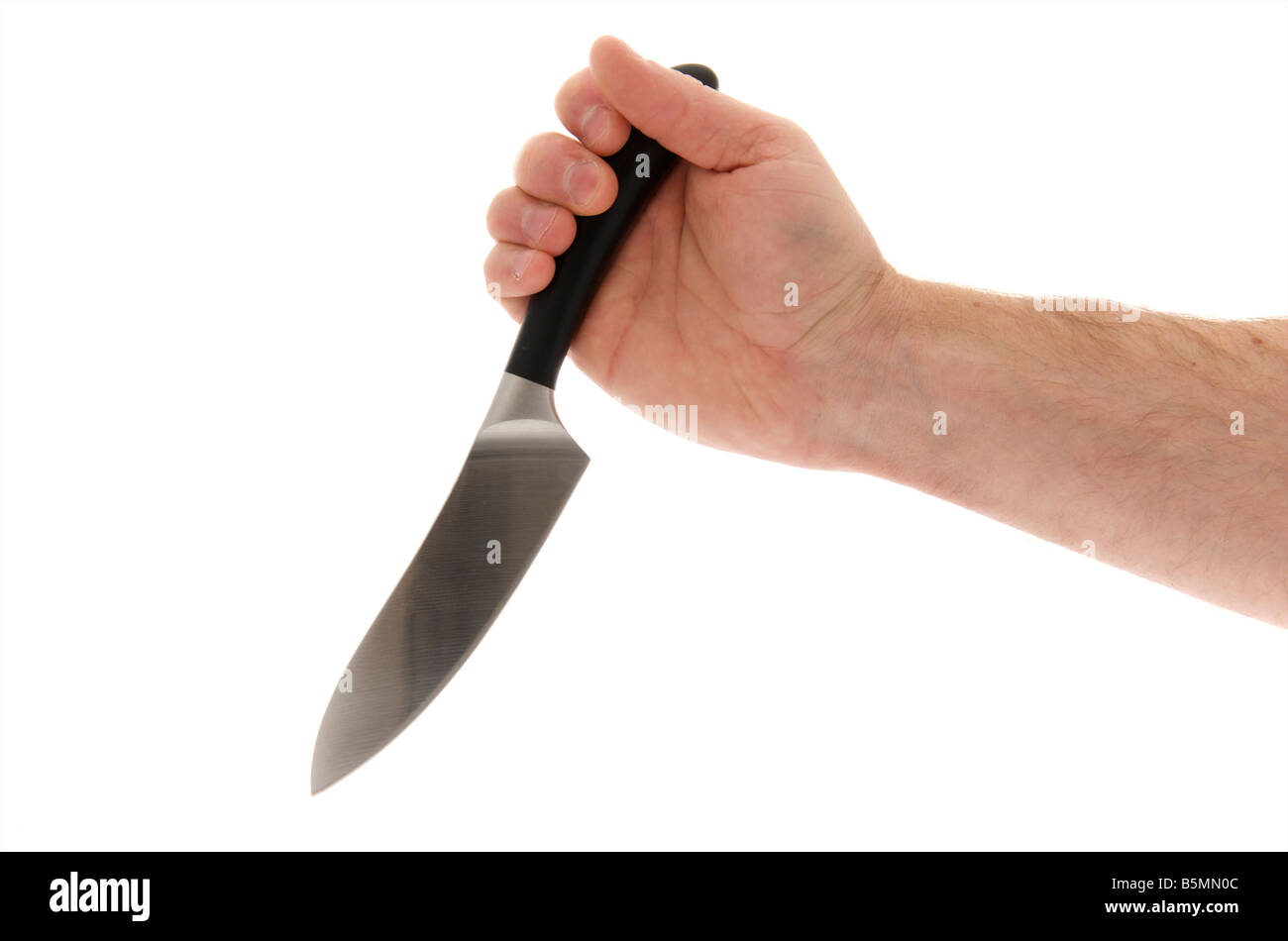 mans male right outstretched hand holding a knife like a dagger against a white background Stock Photo