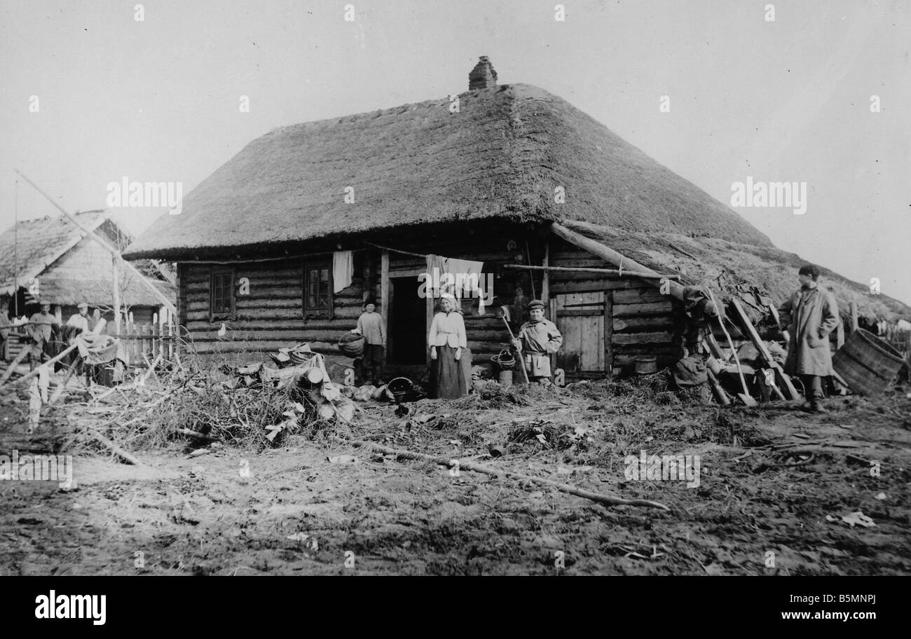 2 V60 P1 1916 7 E Polish peasant family Wooden house Ethnology Poland Polish peasant family in front of their wooden house Germa Stock Photo