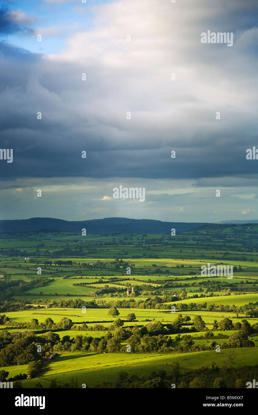 Pastoral Fields and Distant Castle Ruin Near Clonea, Viewed from Croghaun Hill,  County Waterford, Ireland Stock Photo