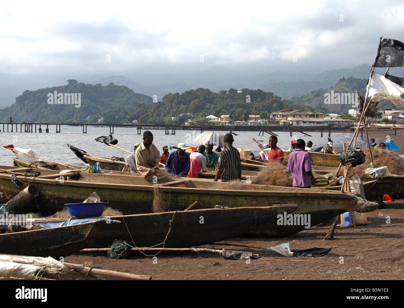 Fishermen and boats at Limbé Cameroon West Africa Mount Cameroon in background Stock Photo