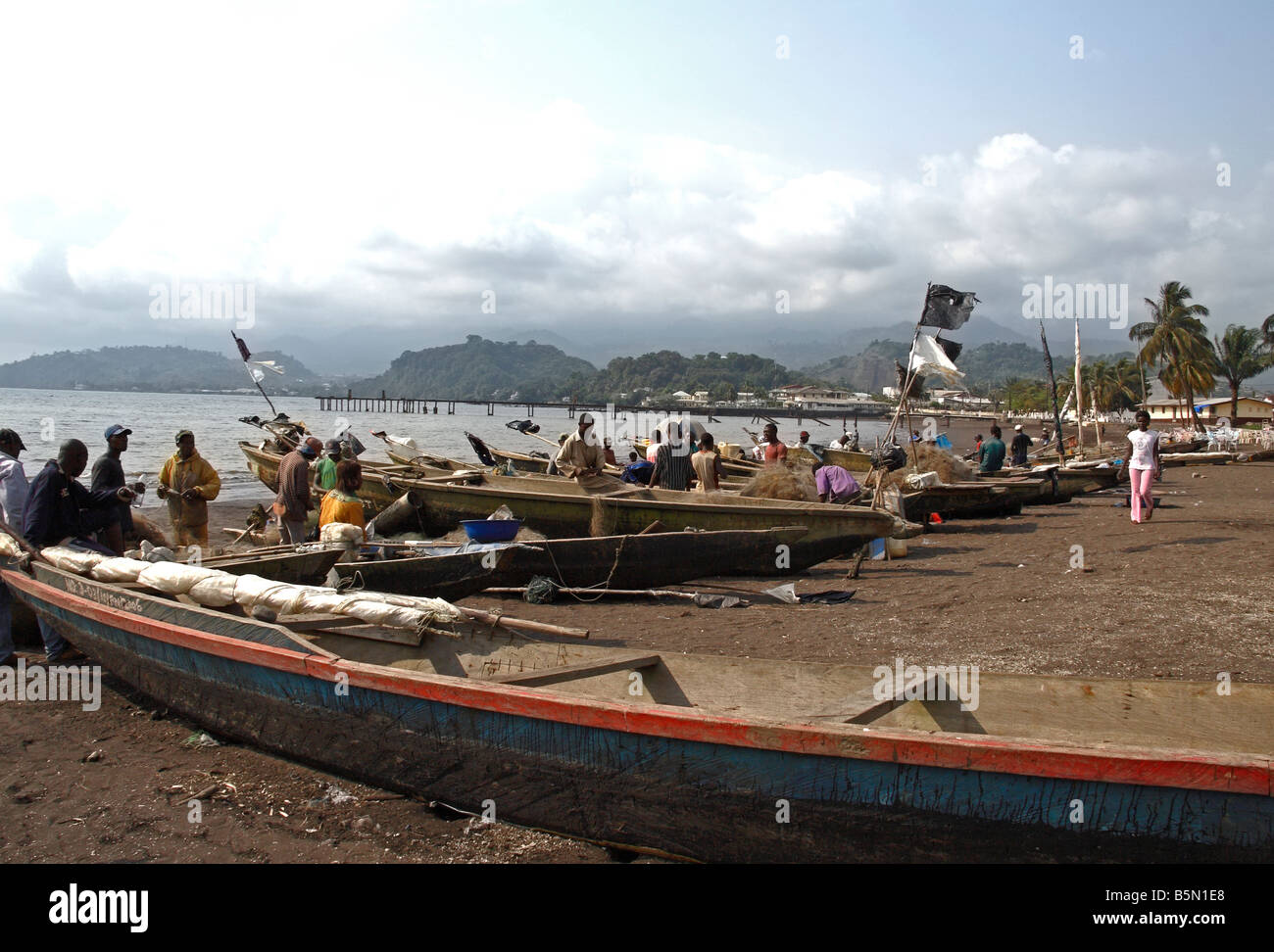 Fishermen and boats at Limbé Cameroon West Africa Mount Cameroon in background Stock Photo