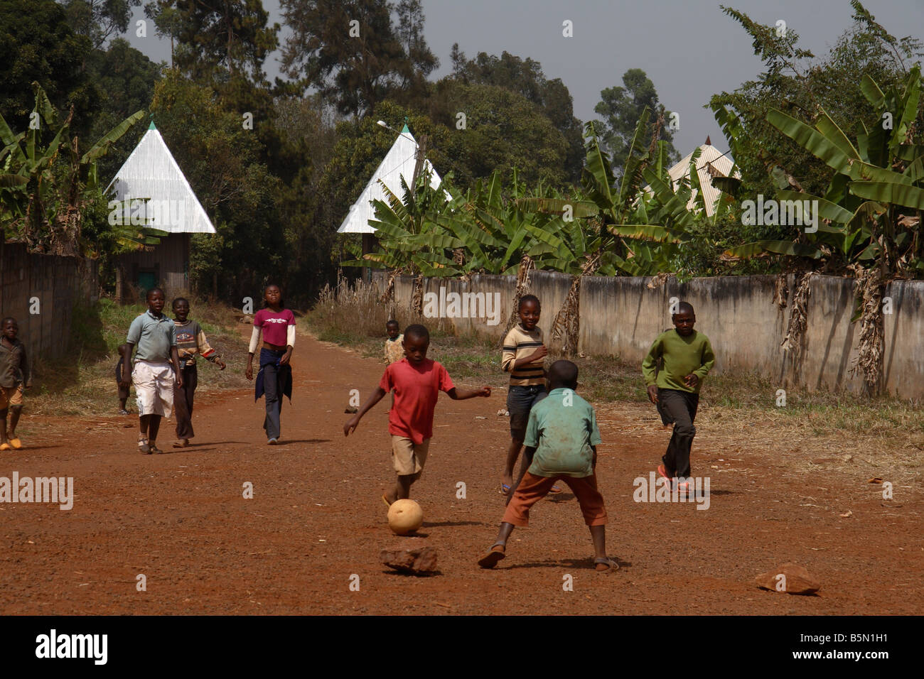 Boys and girls playing football near Bandjoun West Province Cameroon West Africa Stock Photo