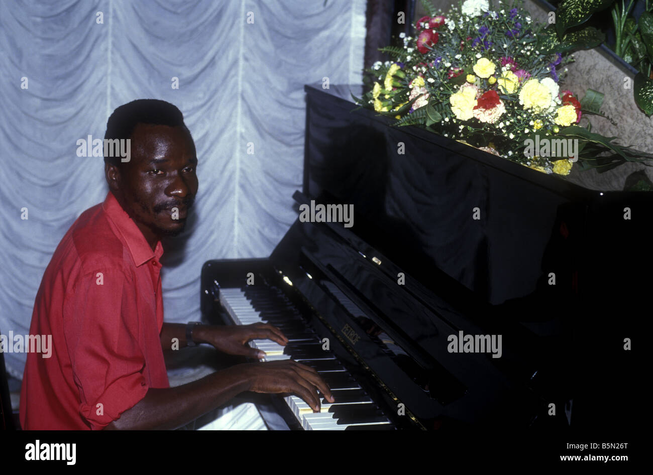 Black African pianist playing PETROF upright piano Kampala Uganda East Africa Stock Photo