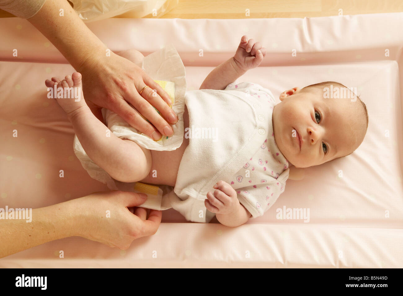 Mother changing baby's diaper Stock Photo Alamy
