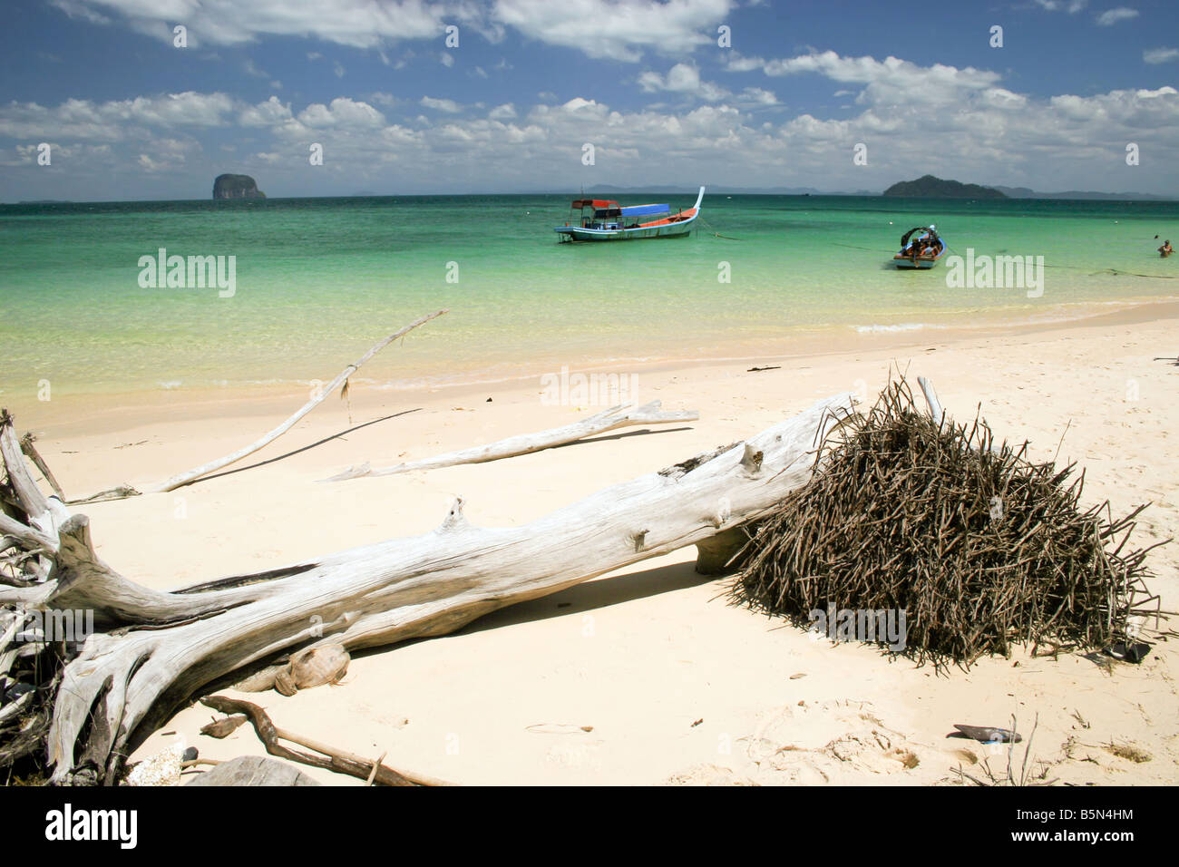 wild tropical beach with colorful boat in thailand, ko bulon island