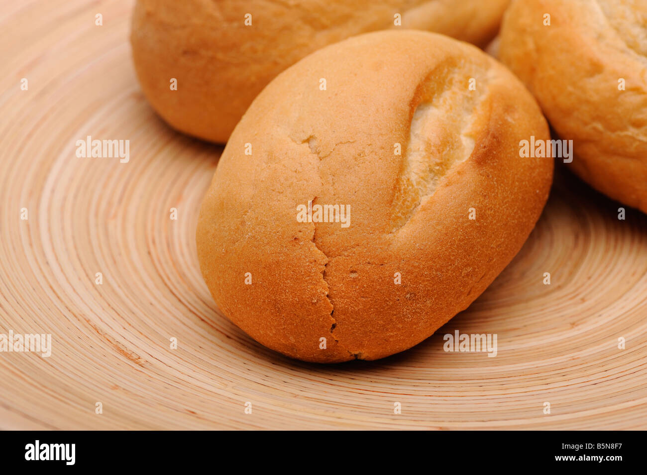 White bread on a round wooden plate Stock Photo Alamy