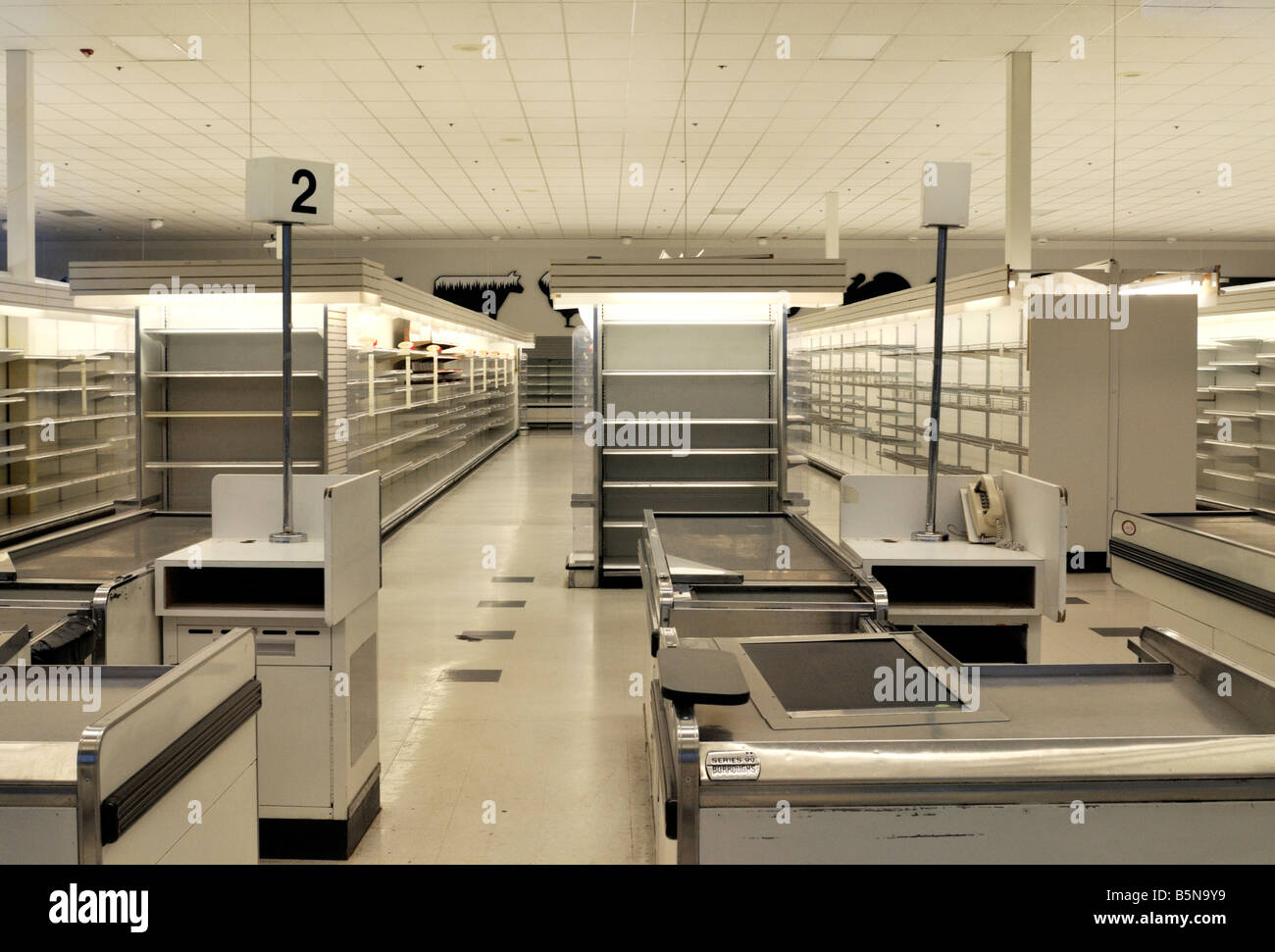 View of empty grocery store with empty shelves gone out of business during tough economic times in America Stock Photo