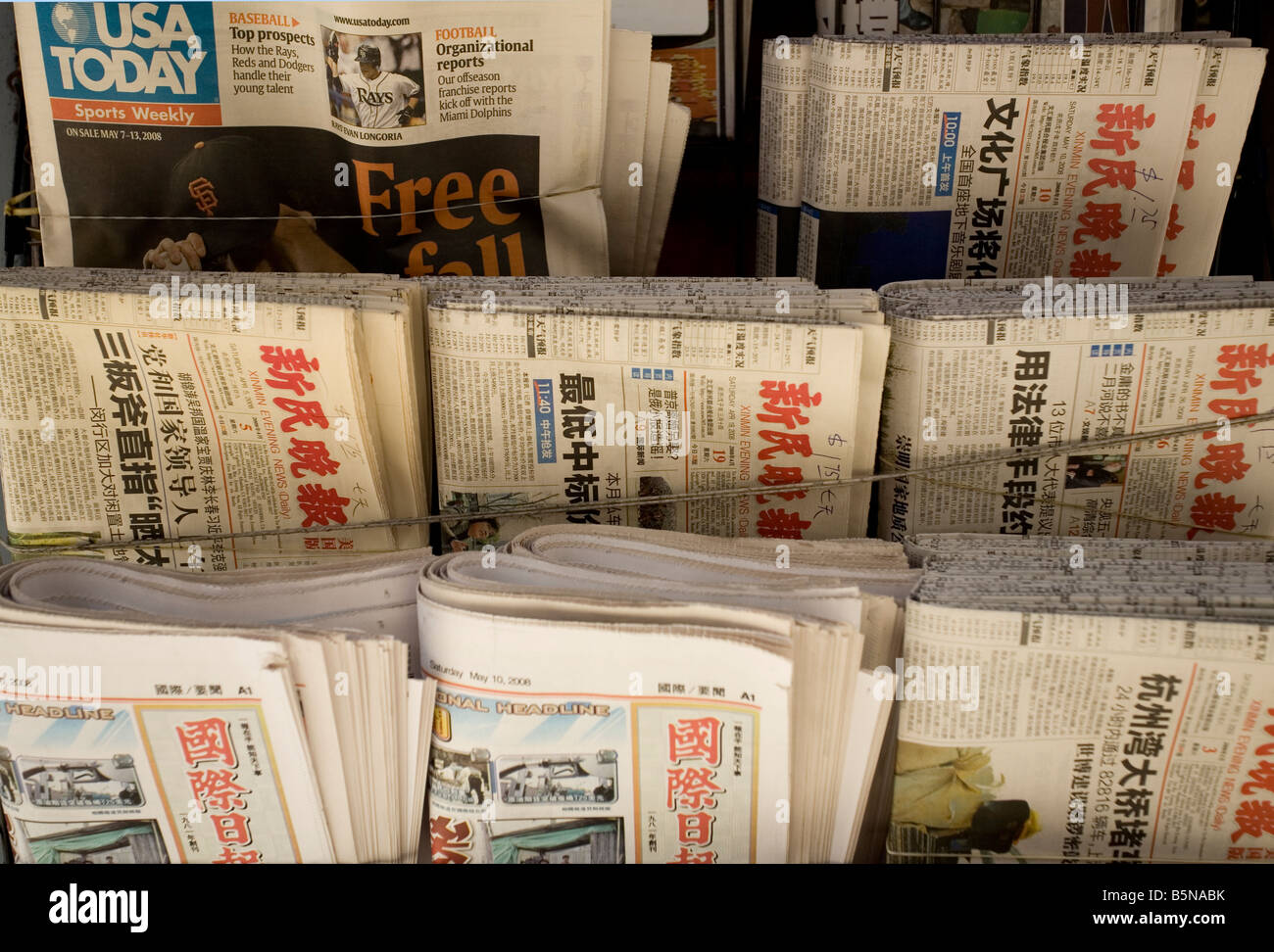 Newspaper Stand with paper reading Free Fall Stock Photo