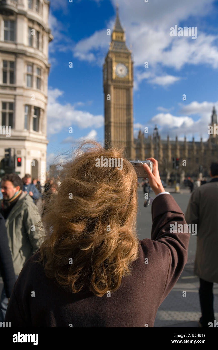 redhead taking a photo of big ben in london Stock Photo