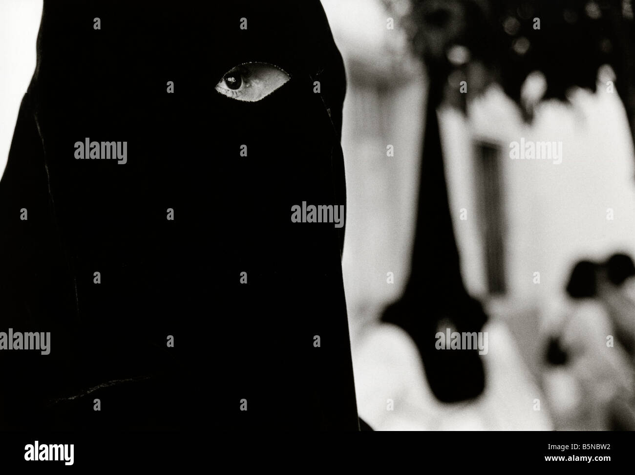 Hooded members of the Brotherhood during the Semana Santa processions in Seville. Spain Stock Photo