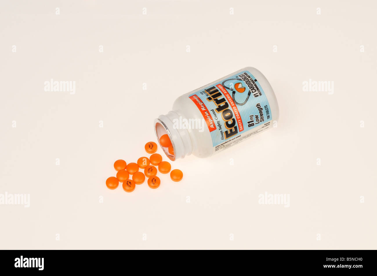 Ecotrin 81 mg low dose aspirin bottle with orange tablets on white background cutout Stock Photo