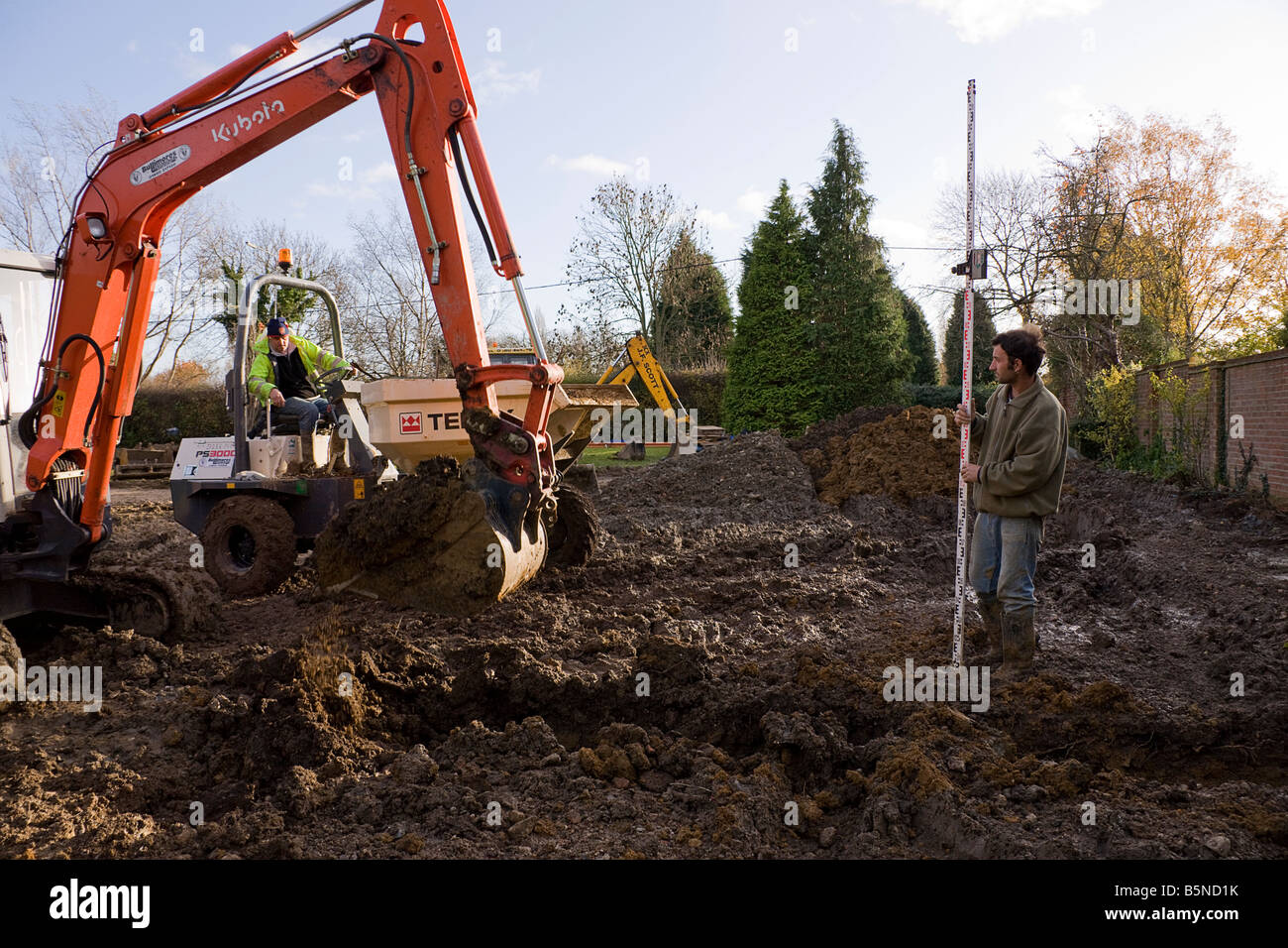 Digging a trench with a digger while preparing the footings. Stock Photo