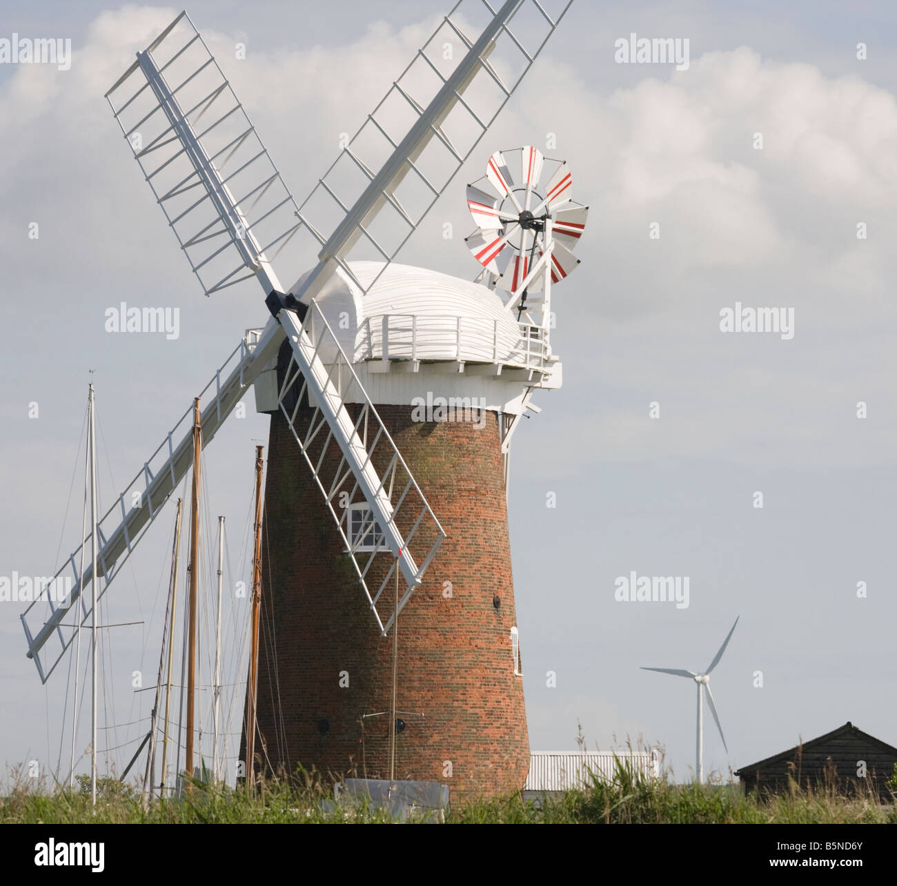 Horsey wind pump Norfolk Broads UK with new wind turbine behind Stock Photo