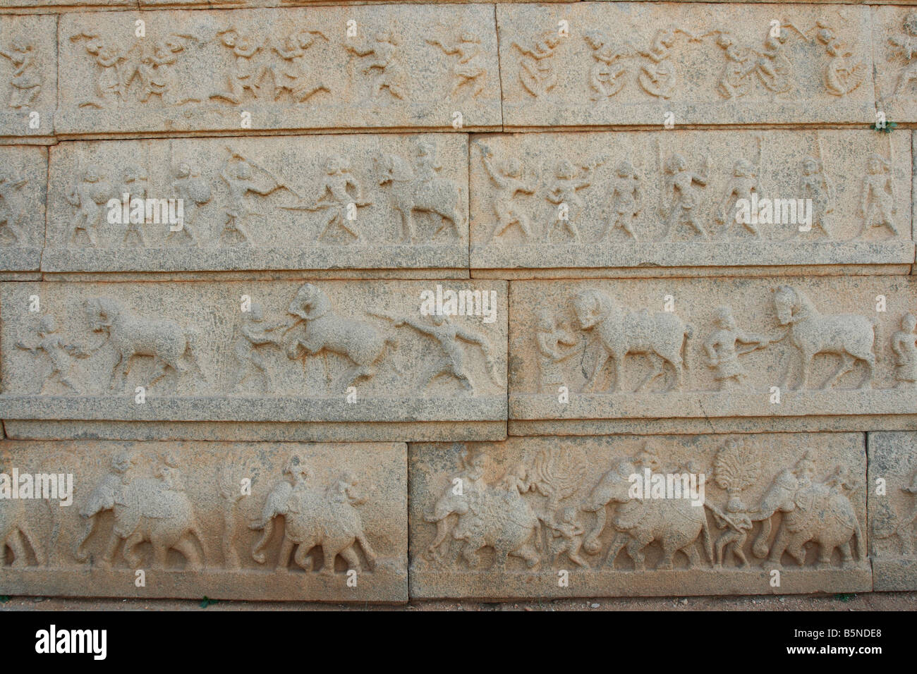 Elephant, horse and camel figures on a wall of a Hindu temple dedicated to Shiva at the ancient site of Hampi, Karnataka, India Stock Photo