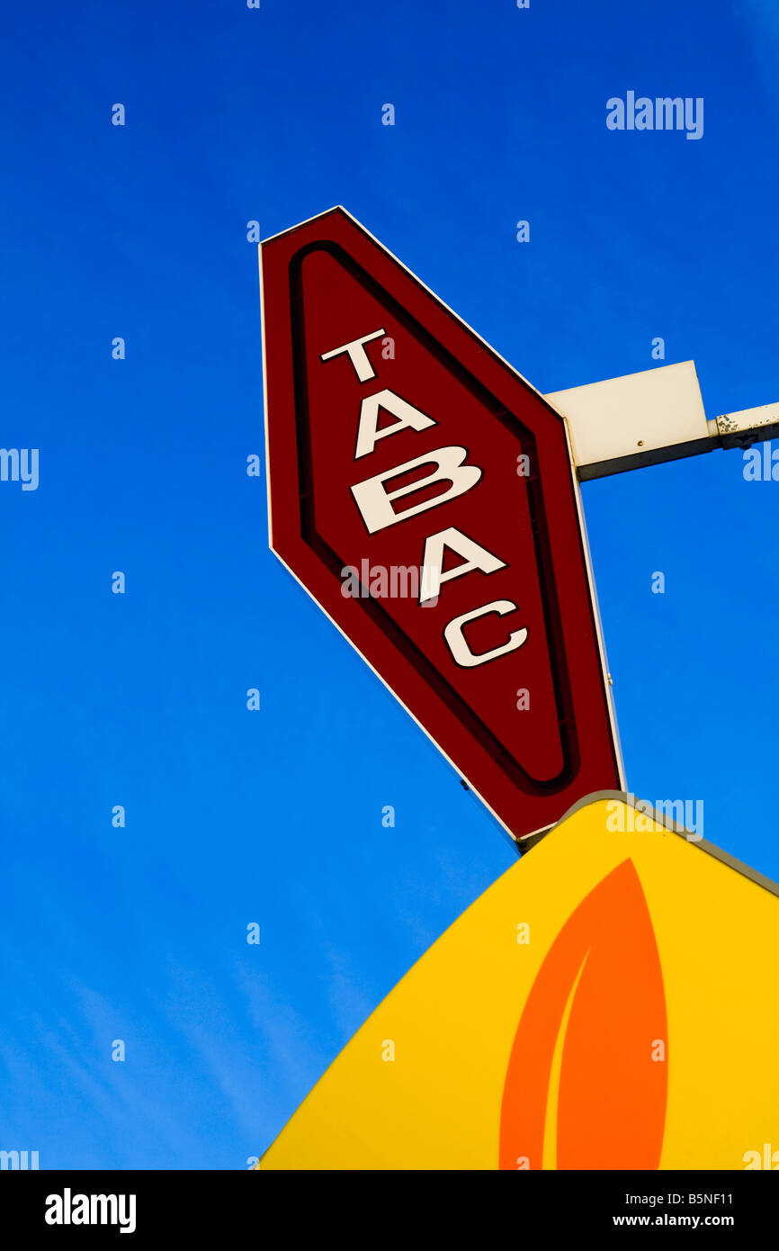 Tabac sign outside a bar and shop selling tobacco products in France with blue sky behind Stock Photo