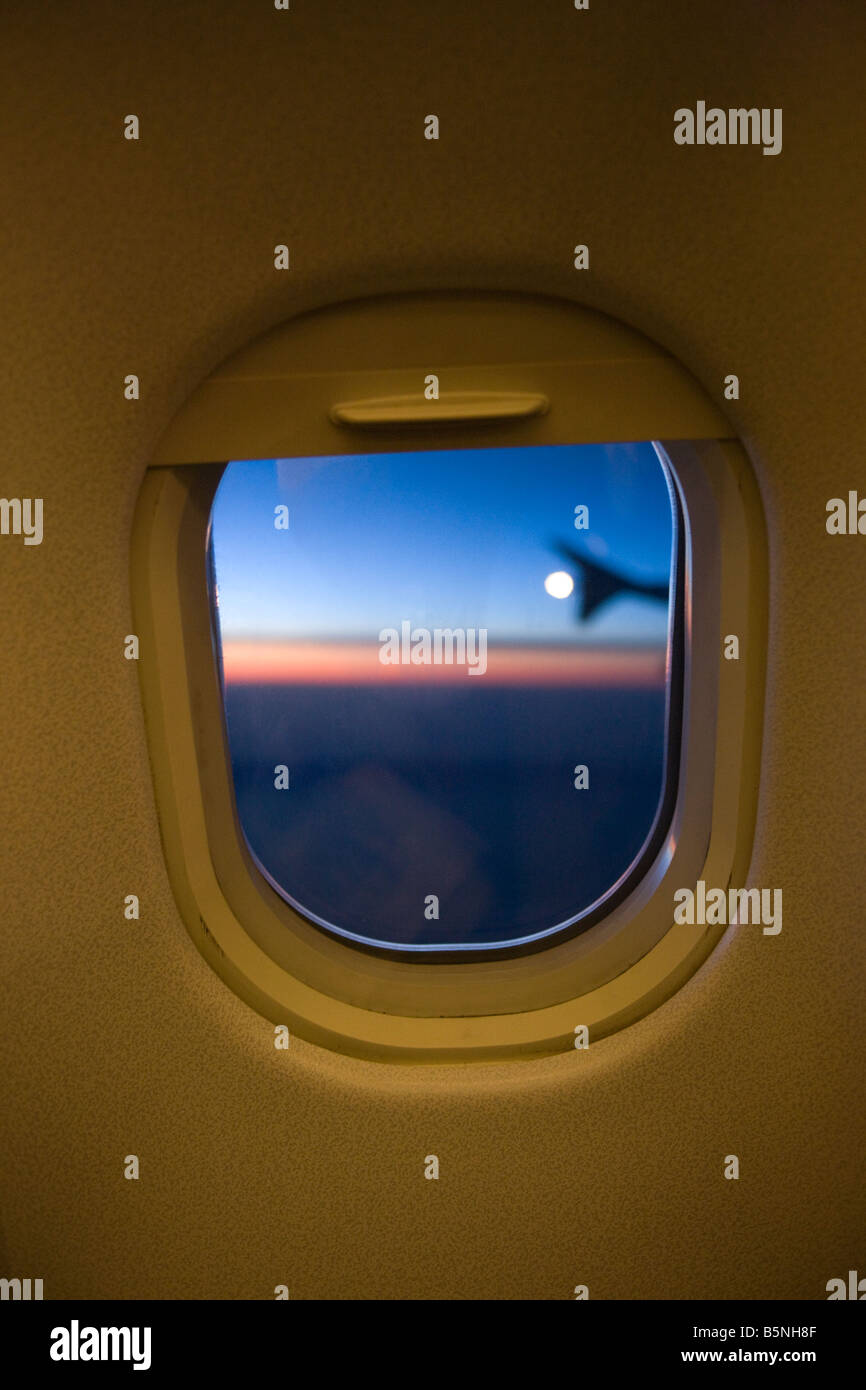 TWILIGHT VIEW THROUGH COMMERCIAL AIRLINER PASSENGER CABIN WINDOW FRAME Stock Photo