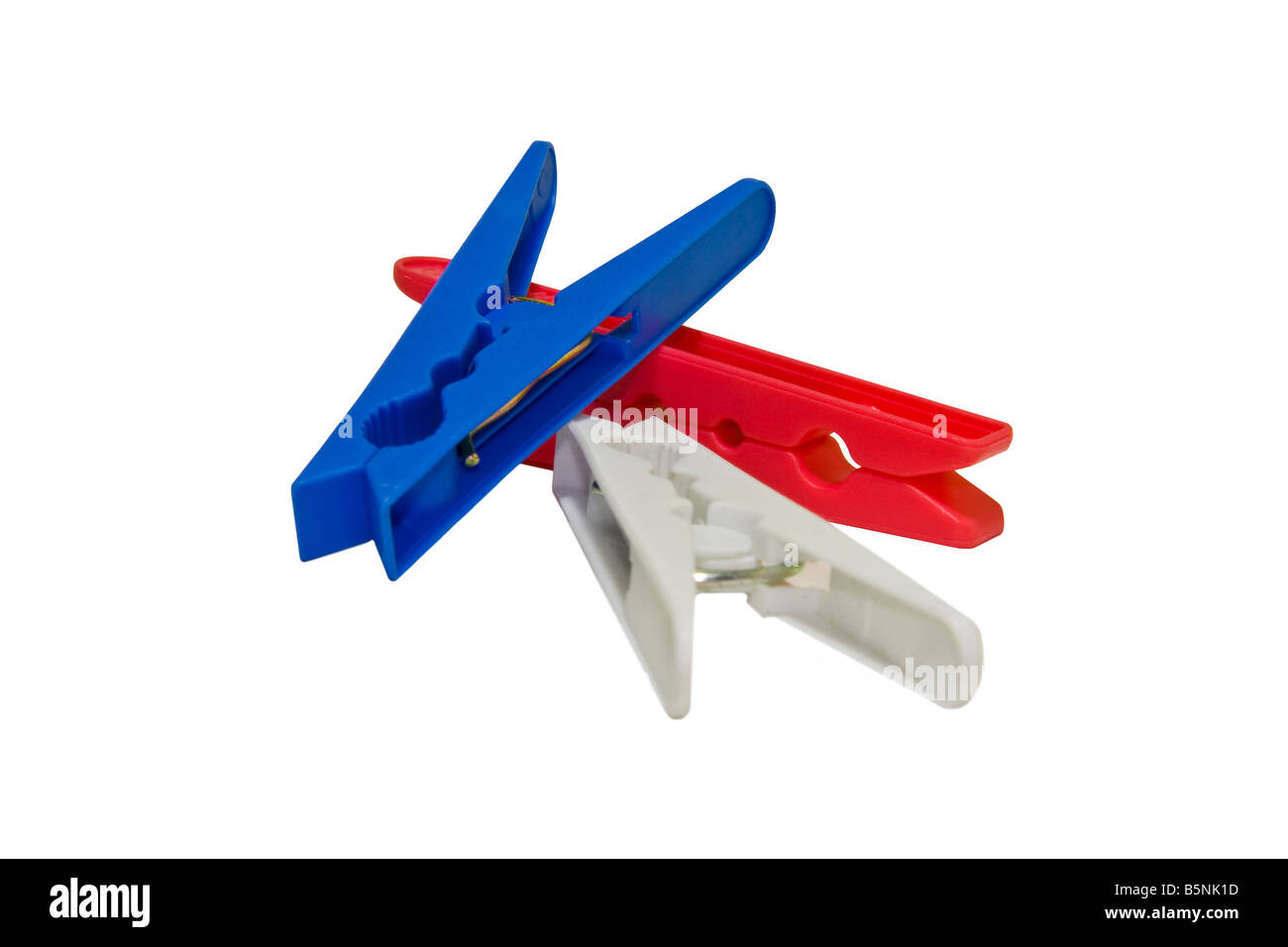 Closeup of three different colored clothes pegs isolated on a white background. Stock Photo