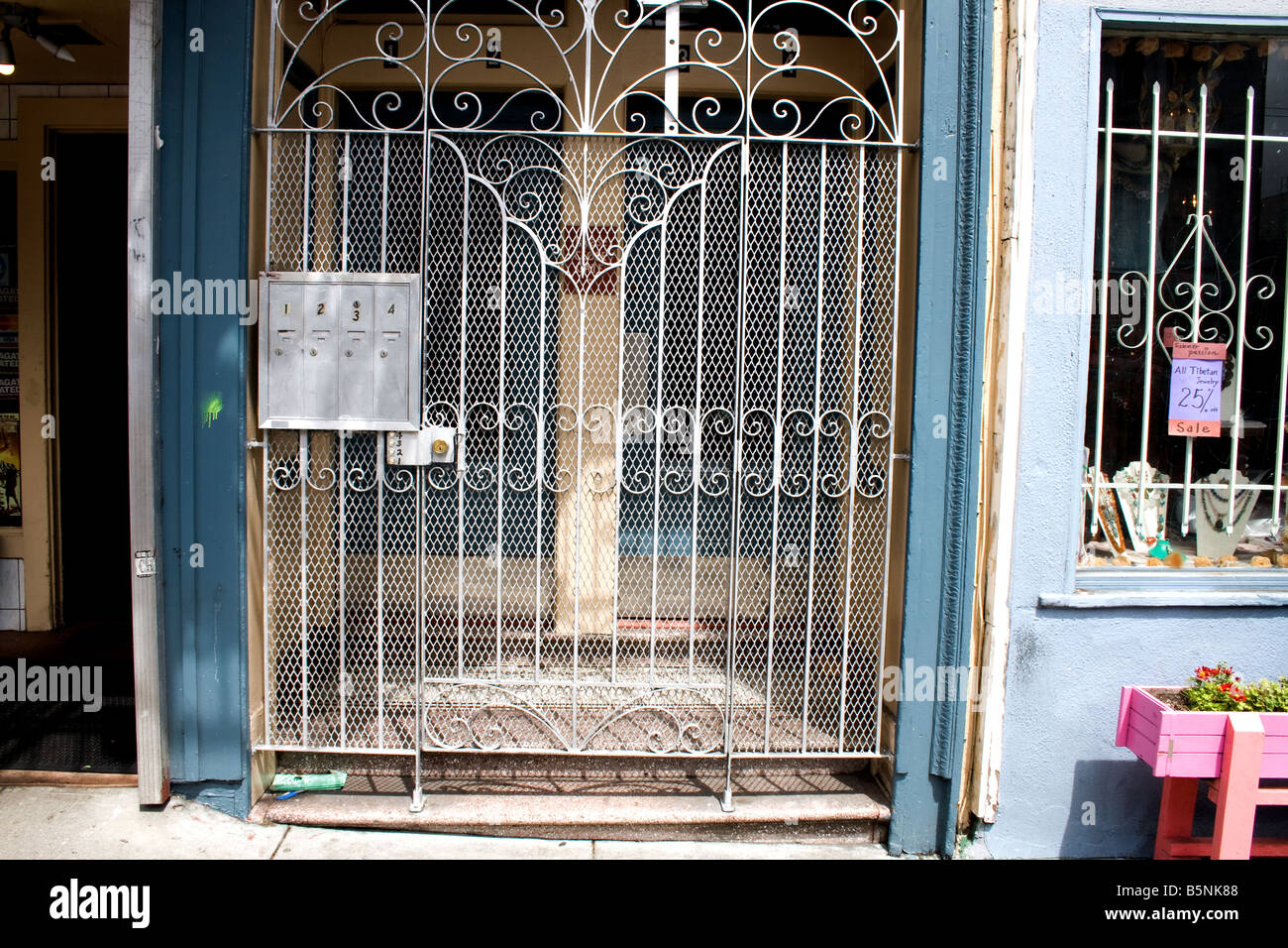 Metal grate door in front of a building next to a store in San Francisco, California Stock Photo
