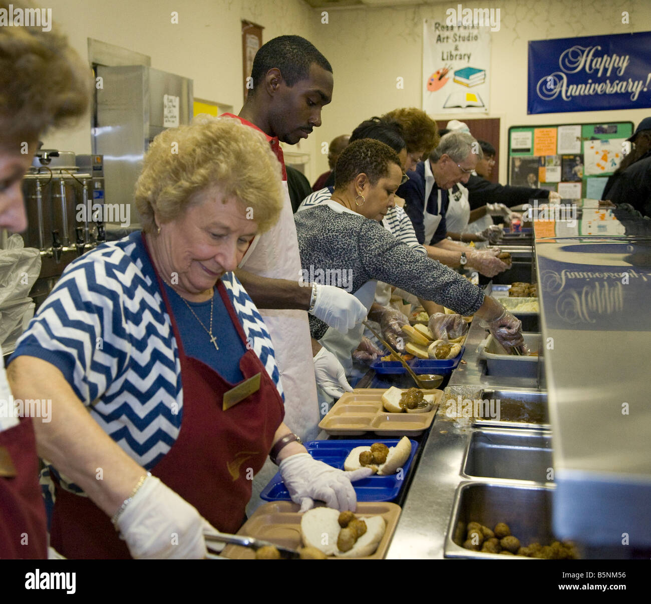 Volunteers Serve Lunch in Soup Kitchen Stock Photo Alamy