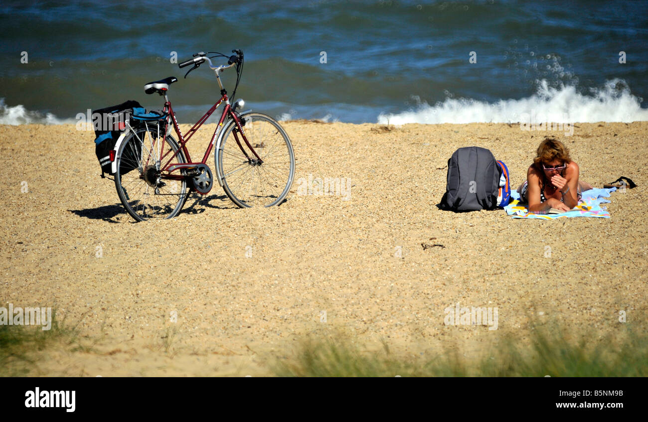 woman relaxing on beach at Southwold Suffolk England Stock Photo