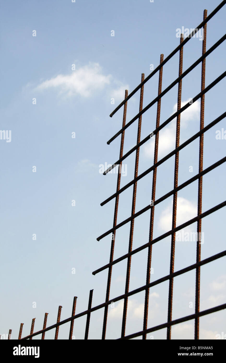 high metal fence with squares and blue sky Stock Photo - Alamy