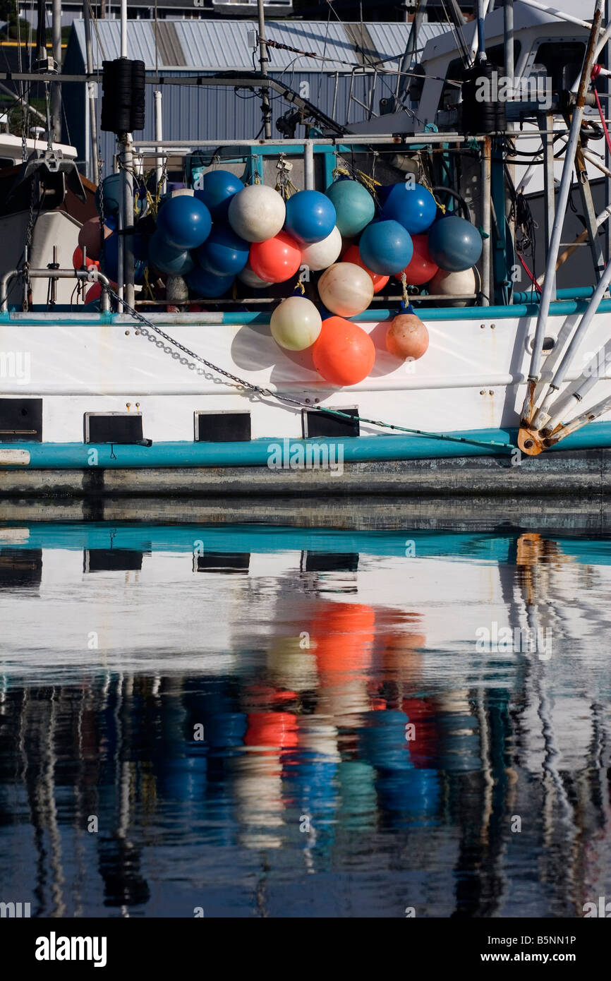 Colorful fishnet floats on the side of a fishing boat in Newport Oregon Stock Photo