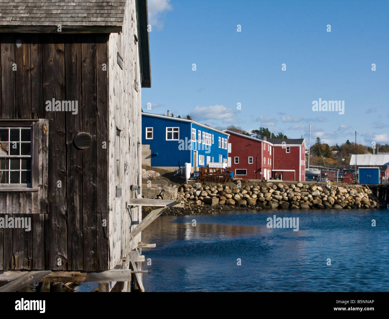 Fishing shack the dory shop with red and blue buildings in the harbour at Lunenburg Nova Scotia Stock Photo