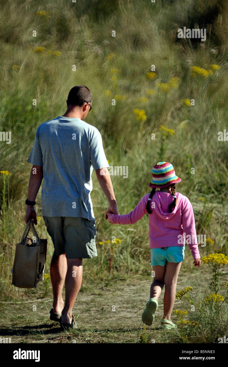 father walking along path with young daughter Stock Photo - Alamy